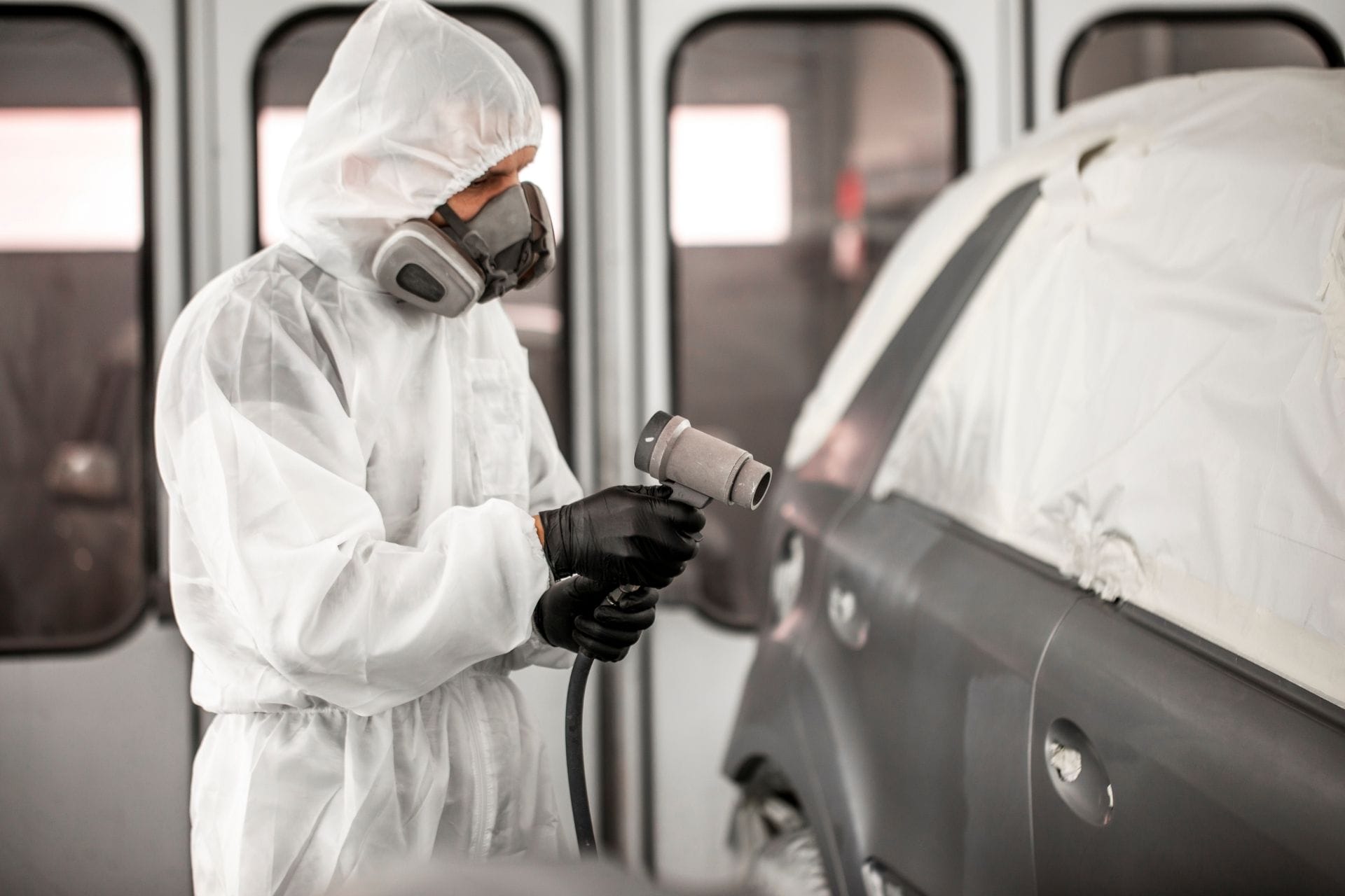 car technician spraying grey paint