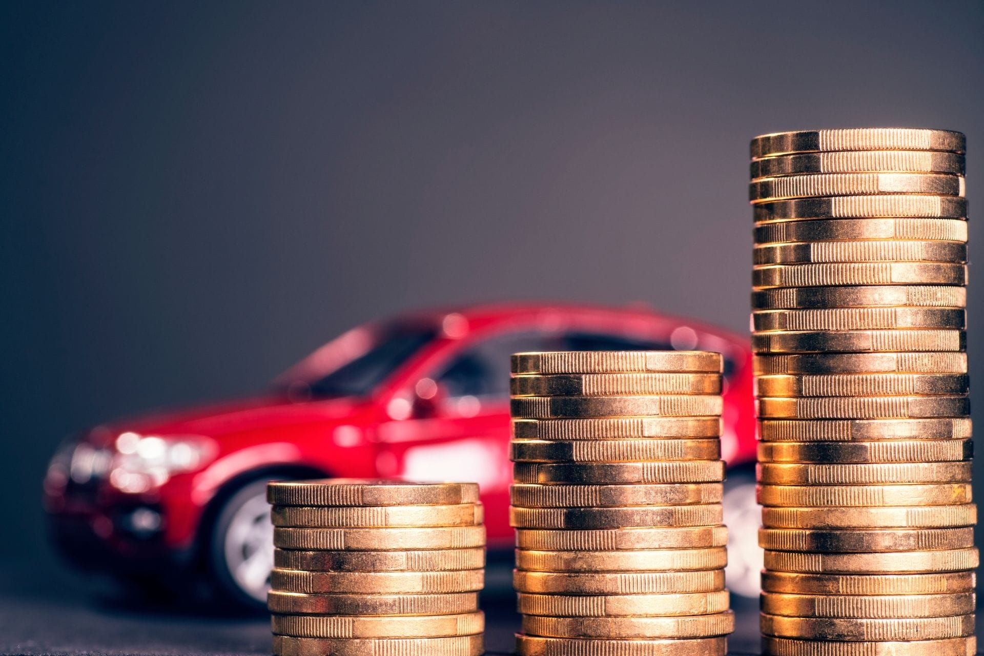 coins and red car