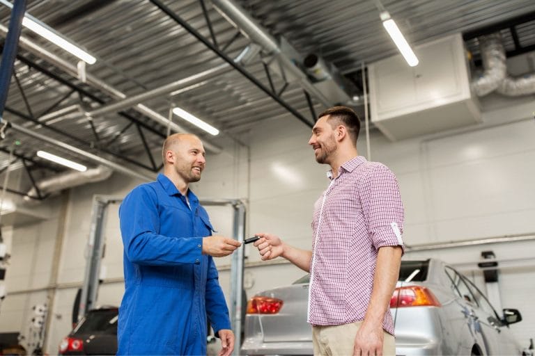 2 guys handing out car key