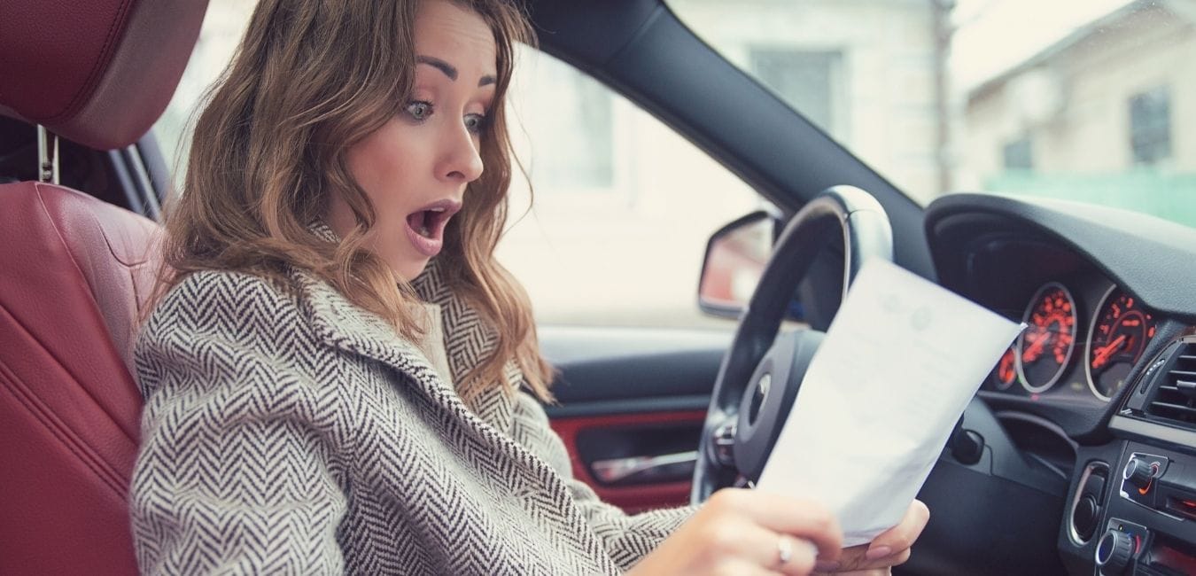 girl shocking holding a paper in car